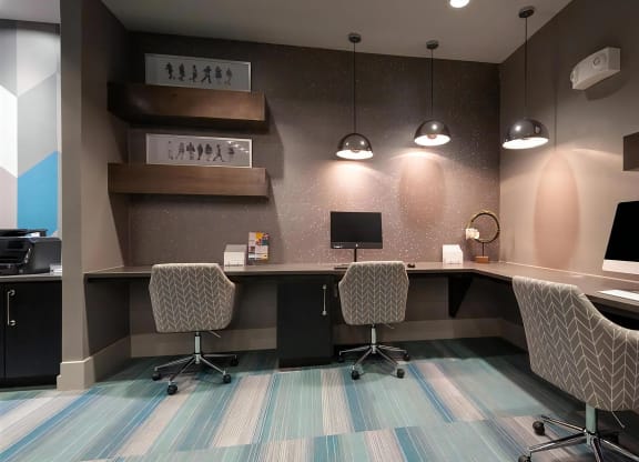 Business Center at Domain at The Gate Featuring Workstations and Modern Lighting