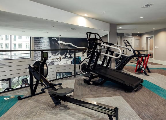 Upper-Level Fitness Space with Rowing Machine, Curved Treadmills, and Plyo Boxes