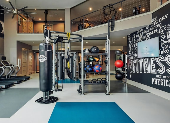 Two-Story Fitness Center with Treadmills, Boxing Bag, and Training Stations