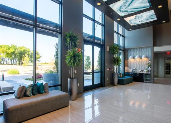 Spacious Main Entryway Featuring Large Windows and Guest Seating Area