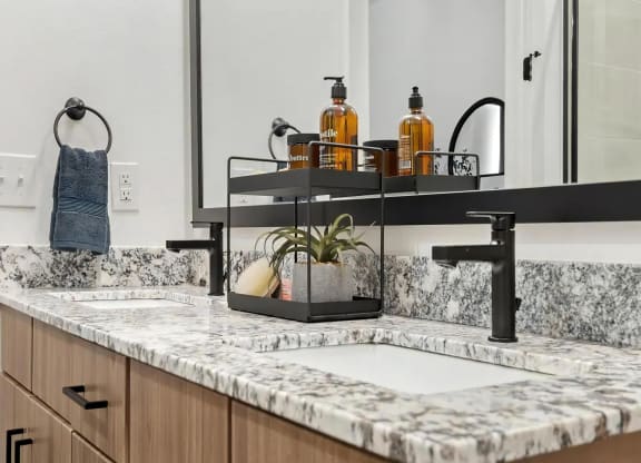Double Bathroom Vanities with Granite Countertops and Dual Mirrors
