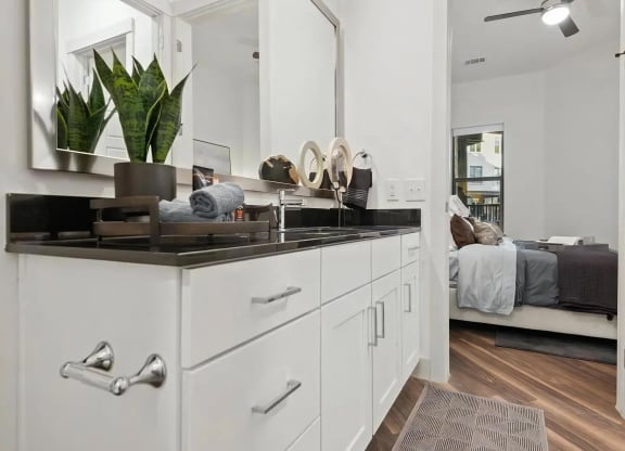 Apartment Bathroom with Sink Vanity and View Into Bedroom