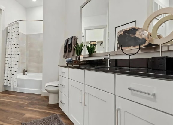 Apartment Bathroom Featuring Shower and Cabinetry Storage