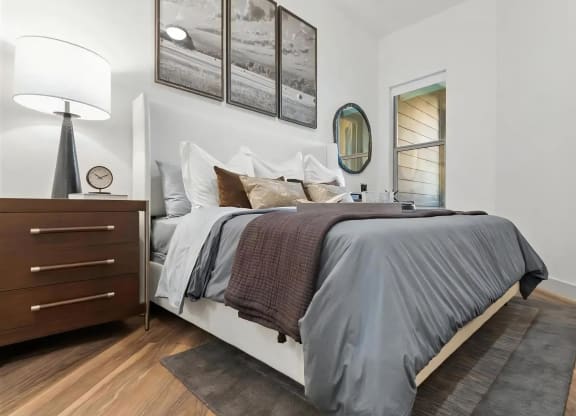 Bedroom with King Bed, Nightstand, and Framed Wall Art