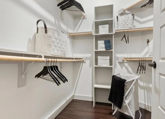 Walk-In Closet with Built-In Shelves, Hangers, and Laundry Basket