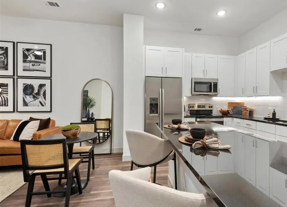 Kitchen Area Featuring Dining Table, Fridge, and Island Seating