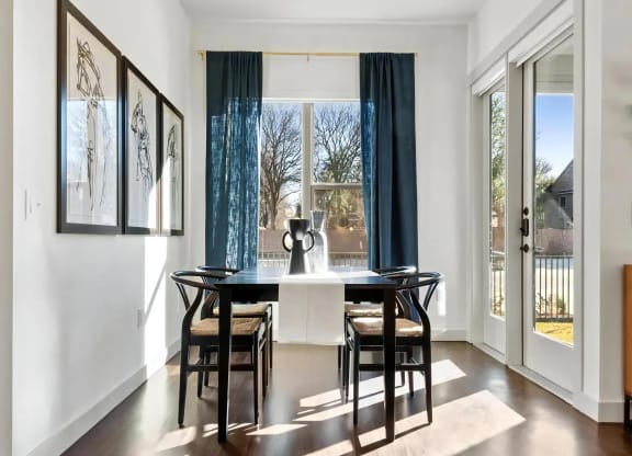 Four-Seat Dining Table Next to Sliding Glass Doors and WindowFour-Seat Dining Table Next to Sliding Glass Doors and Window