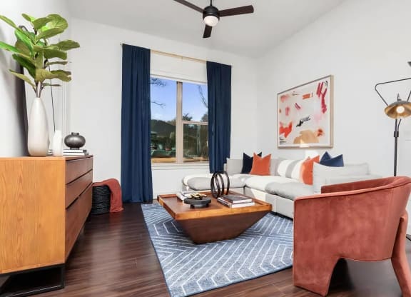 Living Room with Ceiling Fan, Area Rug, and Corner Sofa