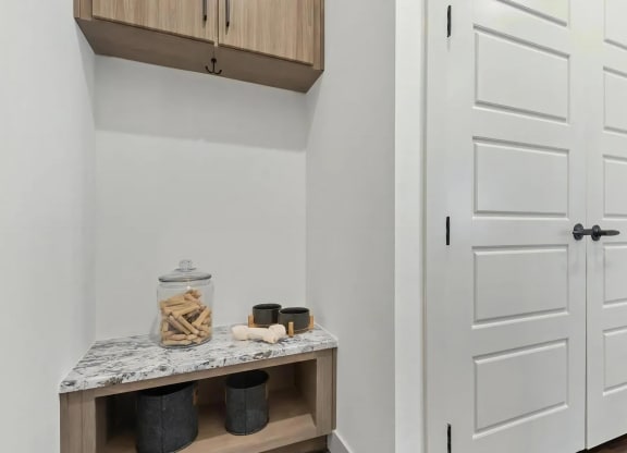 Apartment Entryway Featuring Built-In Cabinets with Storage Hooks