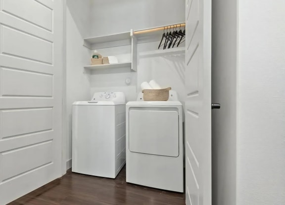 In-Unit Laundry with Washer, Dryer, and Overhead Shelving