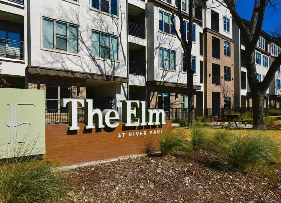 The Elm at River Park Entrance Sign in Front of Apartment Building