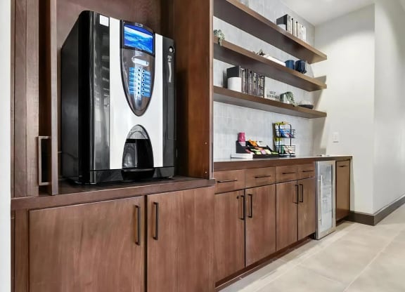 Self-Serve Coffee Machine and Snack Area in Clubhouse Hallway