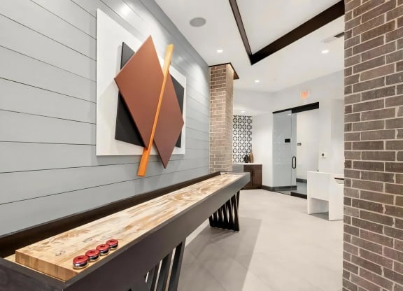 Modern Game Lounge Featuring Shuffleboard and Artistic Decor