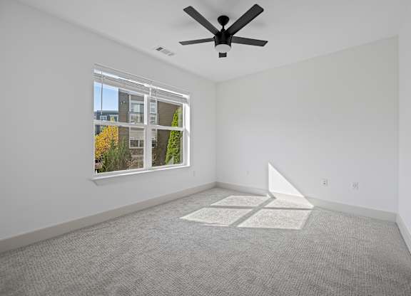 Spacious Bedroom with Carpet and Ceiling Fan and Outdoor Views