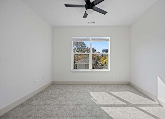 Tranquil Sleeping Space with Natural Light and Modern Fan