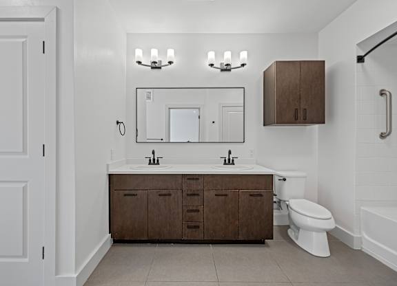 Double Sink Vanity with Dark Wood Cabinets and Sleek Black Fixtures