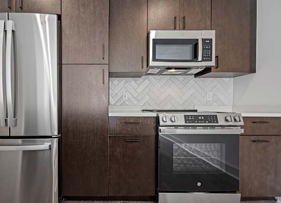 Sleek Kitchen Design with Stainless Appliances and Dark Wood Cabinets