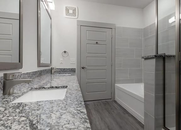 Spa-Inspired Bathroom With Granite Countertops and Dual Bath Options