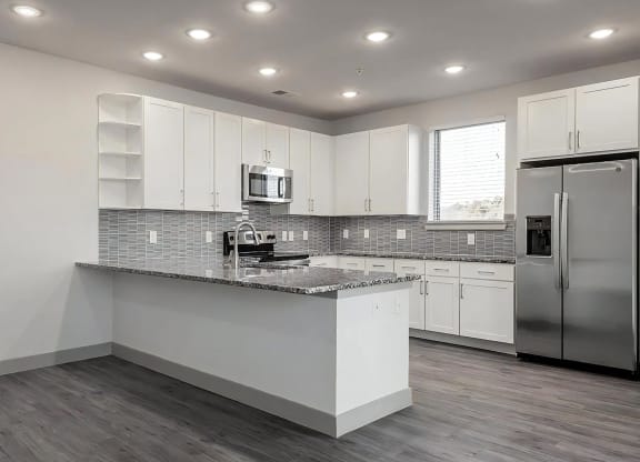 Modern Kitchen with Oversized Granite Breakfast Bar and Ample Storage