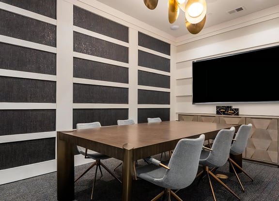 Business Center with Modern Table, Chairs, and TV Display