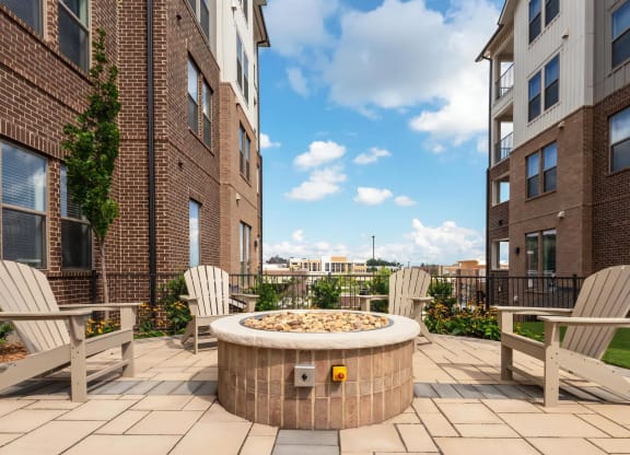 Outdoor Social Space with Fire Pit and Seating Between Apartment Buildings