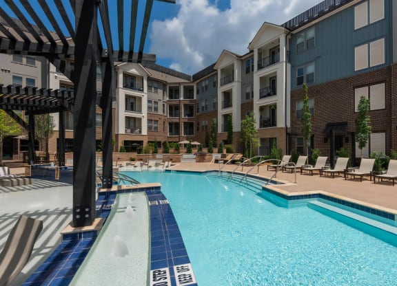 Community Pool Area Featuring Lounge Deck and In-Pool Sun Shelf