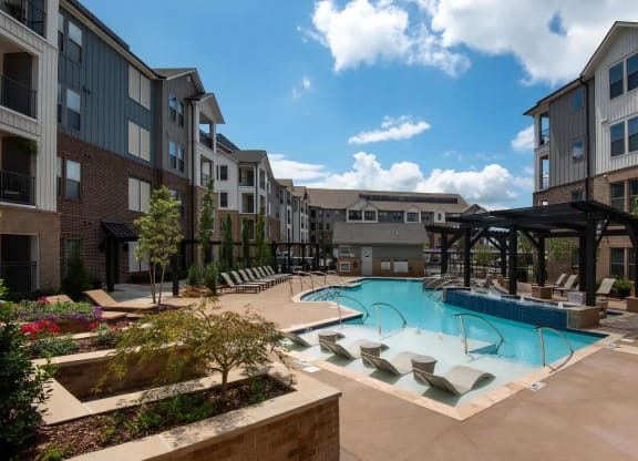 Courtyard Pool Area with Landscaping and Ample Lounge Chairs