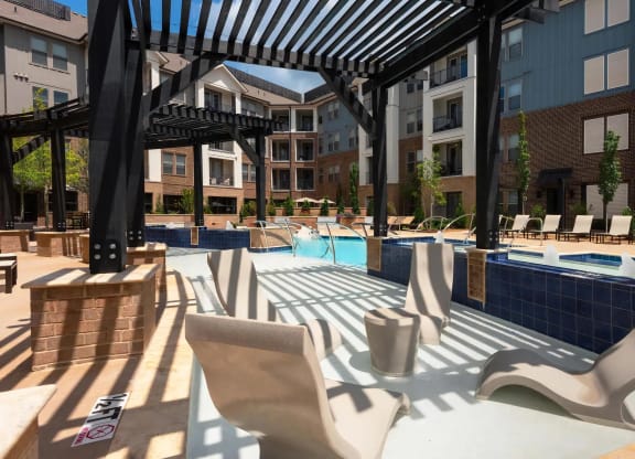 Poolside Pergola with In-Water Loungers and Modern Seating