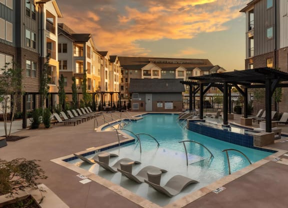 Modern Pool Surrounded by Lounge Chairs and Pergola Seating