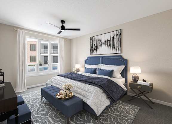 a bedroom with a blue and white bed and a ceiling fan