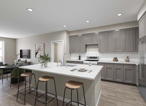 a kitchen with a large island with three stools
