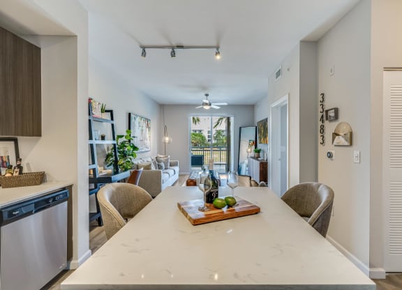 Kitchen Island with Wine Setup and View of Living Room and Balcony