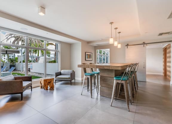 Clubroom with Community Table, Lounge Chairs, and Window Views