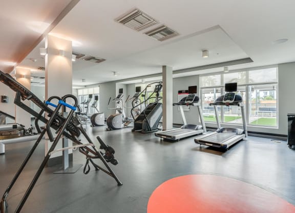 Fitness Center with Cardio Equipment and Outdoor Views Through Large Windows