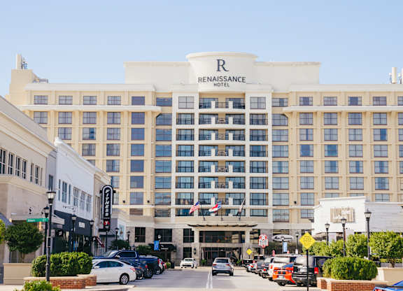 The Renaissance Hotel is a large, white building with a lot of windows.