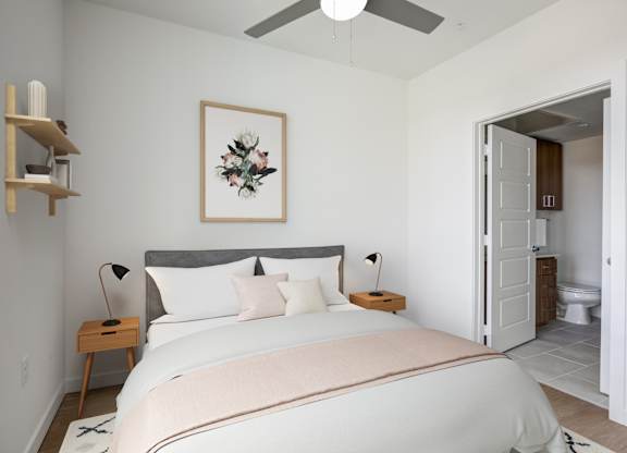 a bedroom with a large bed and a ceiling fan
