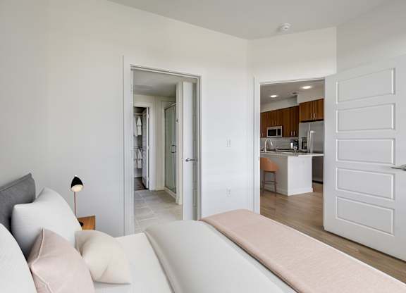 a living room with a couch and a door to a kitchen
