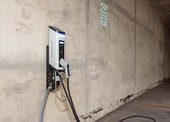 An electric vehicle charging station is installed in a concrete tunnel.