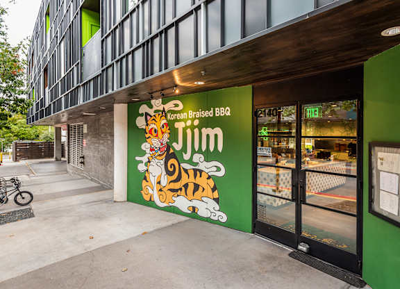 A green building with a tiger on the sign.