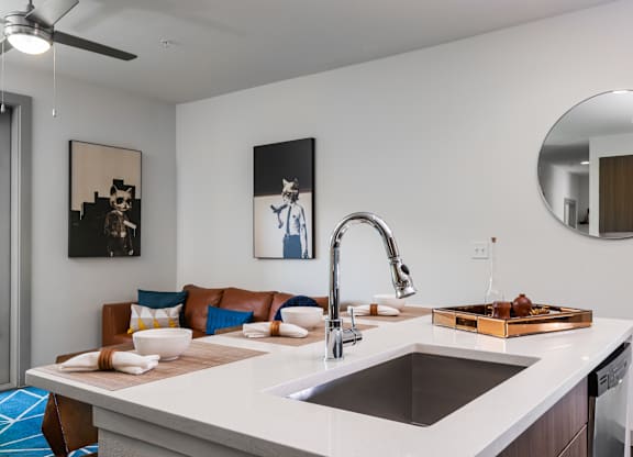 A modern kitchen with a white countertop and a brown tray on it.