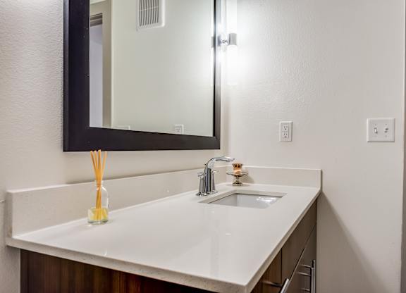 A bathroom sink with a mirror above it.