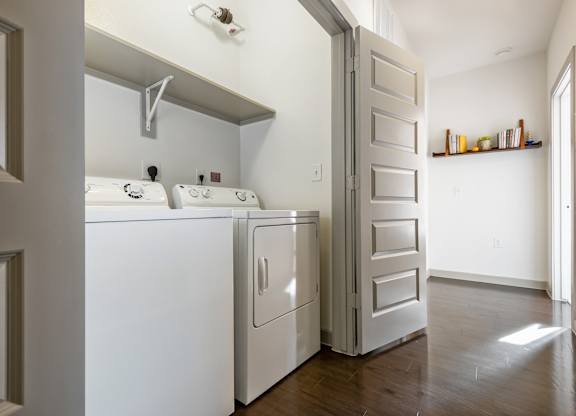 A white washer and dryer in a laundry room.
