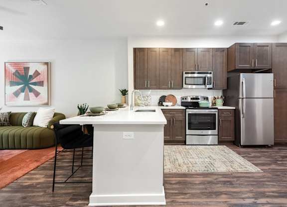 Spacious Kitchen with Sleek Cabinetry and Stainless Steel Finishes