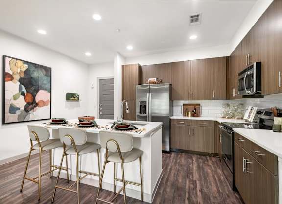 Fully-Equipped Kitchen with Stainless Steel Appliances and Island Seating