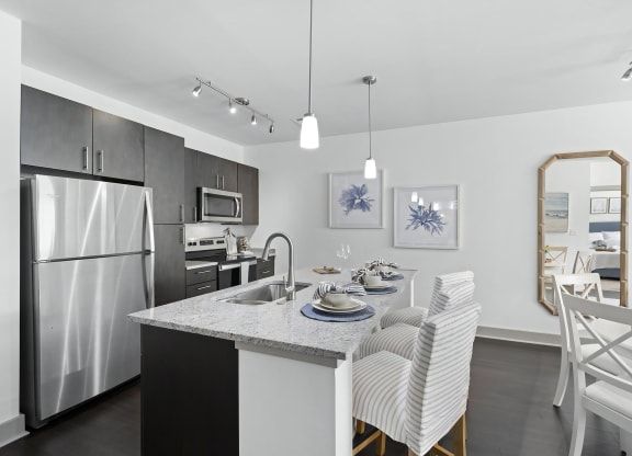 Contemporary Kitchen Featuring Granite Countertops and Pendant Lighting