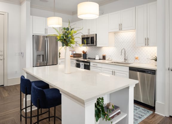 a large white kitchen with a white counter top