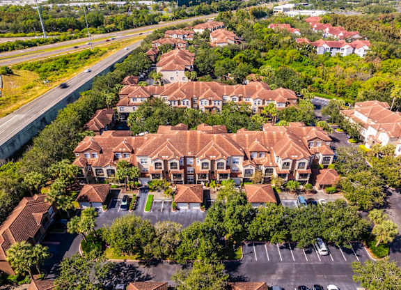 Aerial of residential buildings and parking area alongside highway access