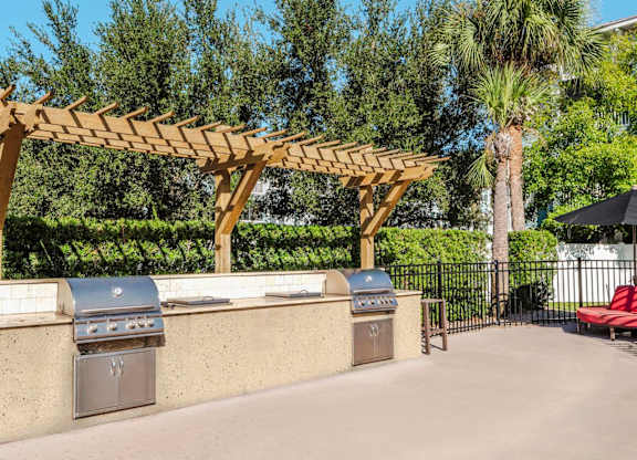 Community grill station with twin stainless grills under pergola