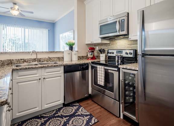 Kitchen with stainless appliances, granite counters and window light