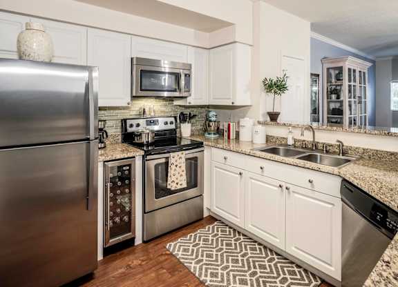 Modern kitchen with stainless appliances and granite counters